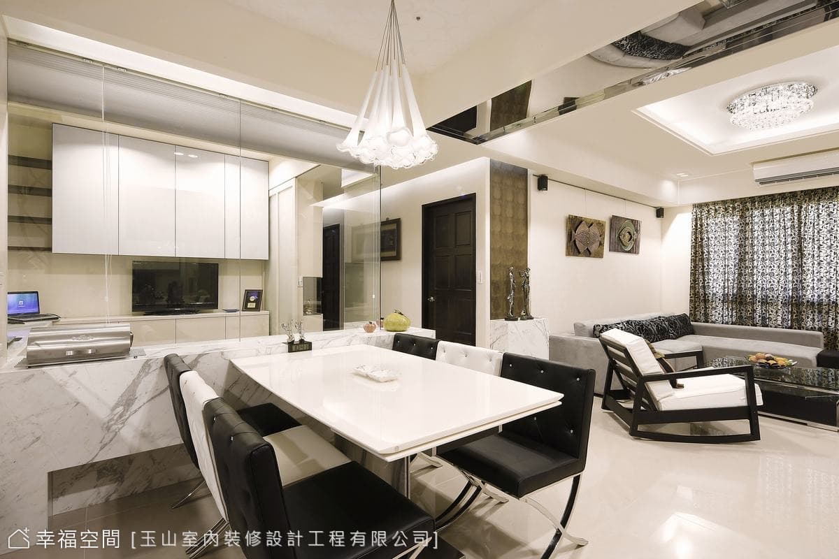 餐廳(2) 設計師利用鏡面反射與穿透玻璃，將原先獨立出來的餐廳空間加倍放大，並使用可雙面使用的銀狐大理石檯面，將餐廳後方的客房空